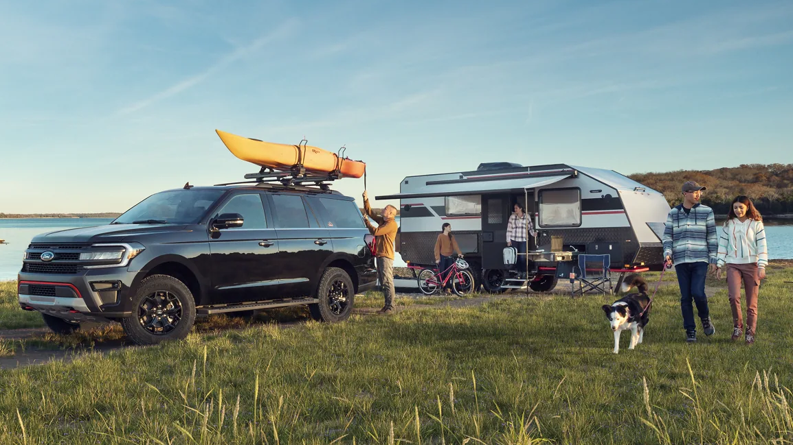 Family camping with their black 2023 Ford Expedition.