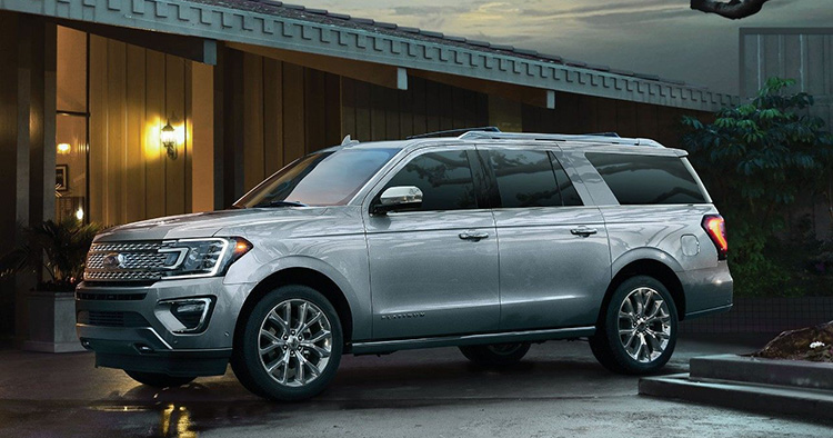 Image of a silver 2019 FOrd Expedition parked in front of a house.