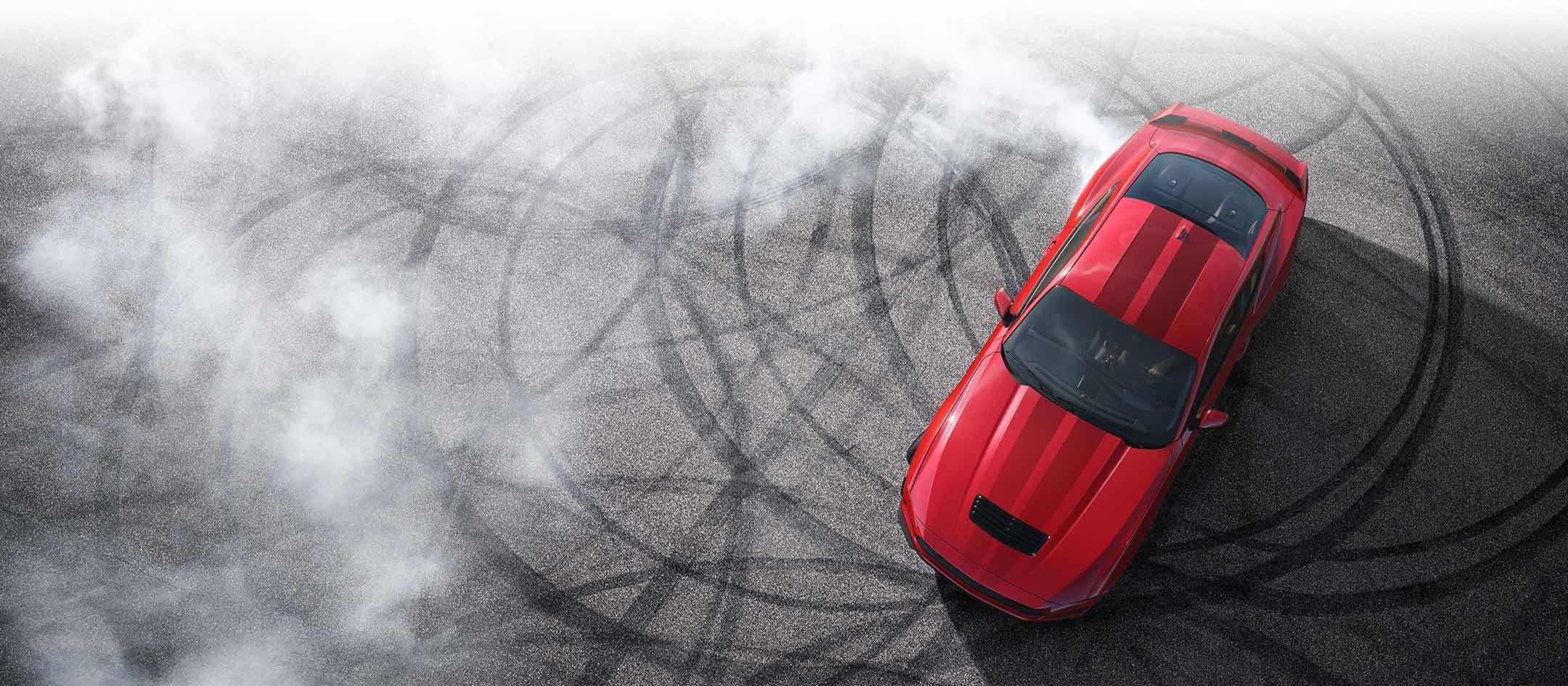 Overhead view of a 2024 Ford Mustang® model with tire tracks on pavement | Griffin Ford Fort Atkinson in Fort Atkinson WI