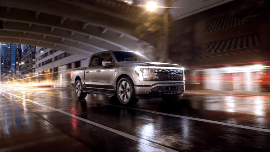 The futuristic 2022 Ford F-150 drives through a city tunnel at night